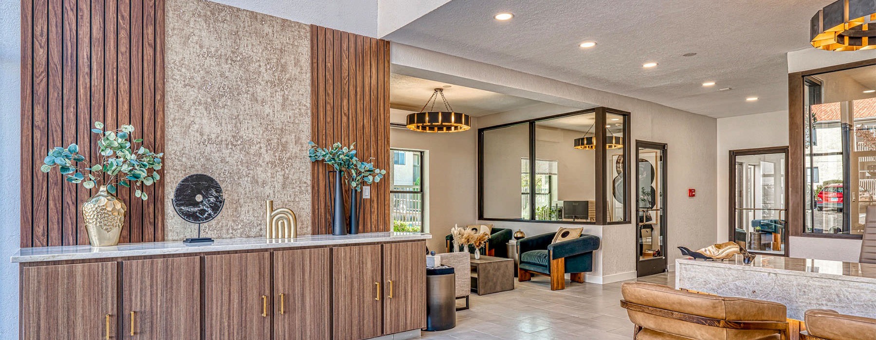 lobby of building with desk and chairs